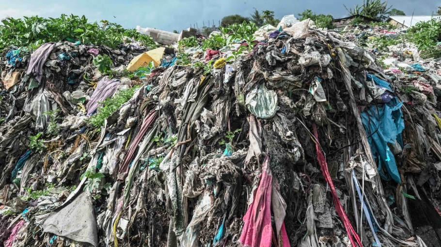 NAKURU, KENYA - 2026/04/14: Decomposing textile waste (clothing) is seen mixed with other types of wastes at a municipal dumpsite. Rising demand for fast fashion, much of it made from polyester, is increasing the amount of textile waste sent to Global South countries such as Kenya as second-hand clothing. Much of this waste is hard to recycle and ends up polluting the environment. Environmentalists are calling for stricter controls on cross-border waste shipments. (Photo by James Wakibia/SOPA Images/LightRocket via Getty Images)