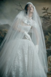Lee Petra Grebenau lace Claire gown embellished with pearls; Nardos illusion tulle topper with floral appliqué; Binata veil; Carolina Amato gloves; Ettika freshwater pearl luxe choker; Ben Amun glass pearl and stone necklace.