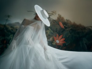 Ines Di Santo The Impression ballgown with a grosgrain covered French Chantilly lace corset and pleated crepe skirt; Gigi Burris hat; Monvieve organza veil; Carolina Amato gloves.