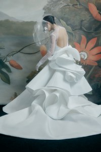 Nardos silk Mikado gown with tulle overlay; Tia Mazza veil headband with silk organza leaves and butterflies; stylist’s own gloves.