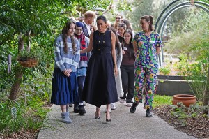 MELBOURNE, AUSTRALIA - APRIL 14: Meghan, Duchess of Sussex walks with adolescent patients and staff in the Kelpie garden on a visit to the Royal Children's Hospital with her husband Prince Harry, Duke of Sussex on April 14, 2026 in Melbourne, Australia. The royal couple are on a four-day visit to Australia, with engagements across Melbourne, Canberra and Sydney. (Photo by Jonathan Brady-Pool/Getty Images)