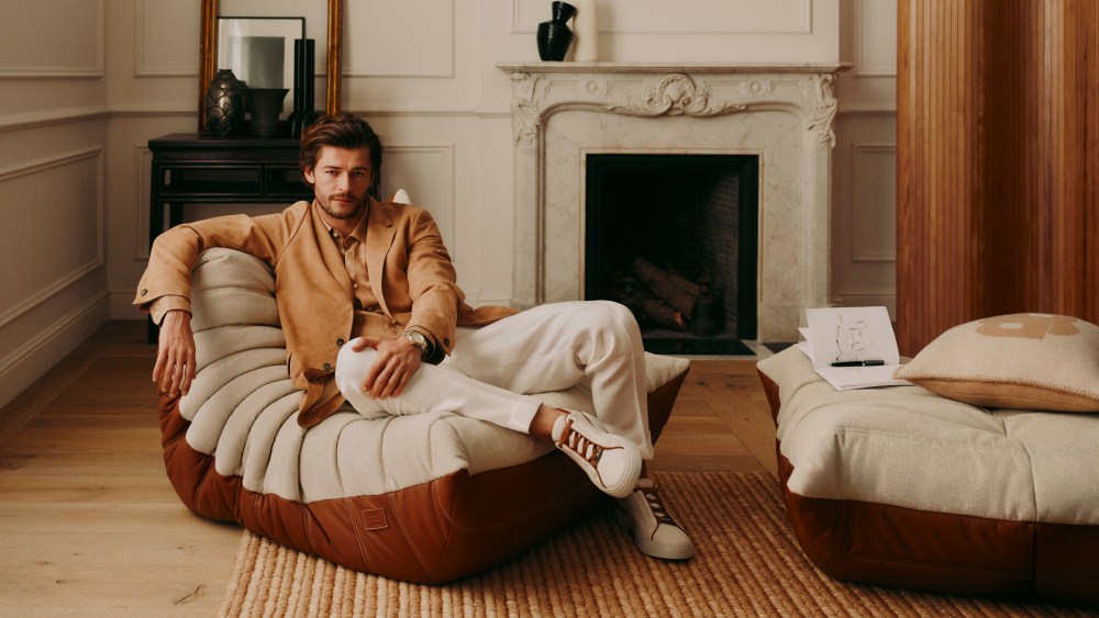 A man sits on Hugo Boss and French design line Ligne Roset's version of the Togo chair.