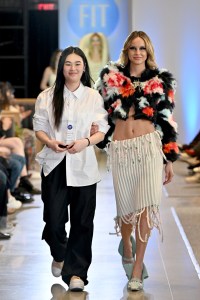 Designer Xuan Mak and a model walk the runway during the FIT's 2026 Future of Fashion runway show on May 07, 2026 in New York City.
