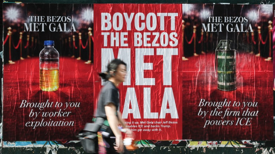 A person walks by "Boycott the Bezos Met Gala" posters in New York City on April 15, 2026. Amazon’s Jeff Bezos and Lauren Sanchez are the lead sponsors and honorary co-chairs of the 2026 Met Gala, taking place on May 4th.